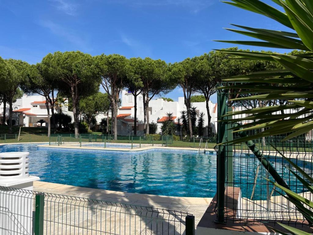 a swimming pool with a fence around it at Casa Hortensia in Chiclana de la Frontera
