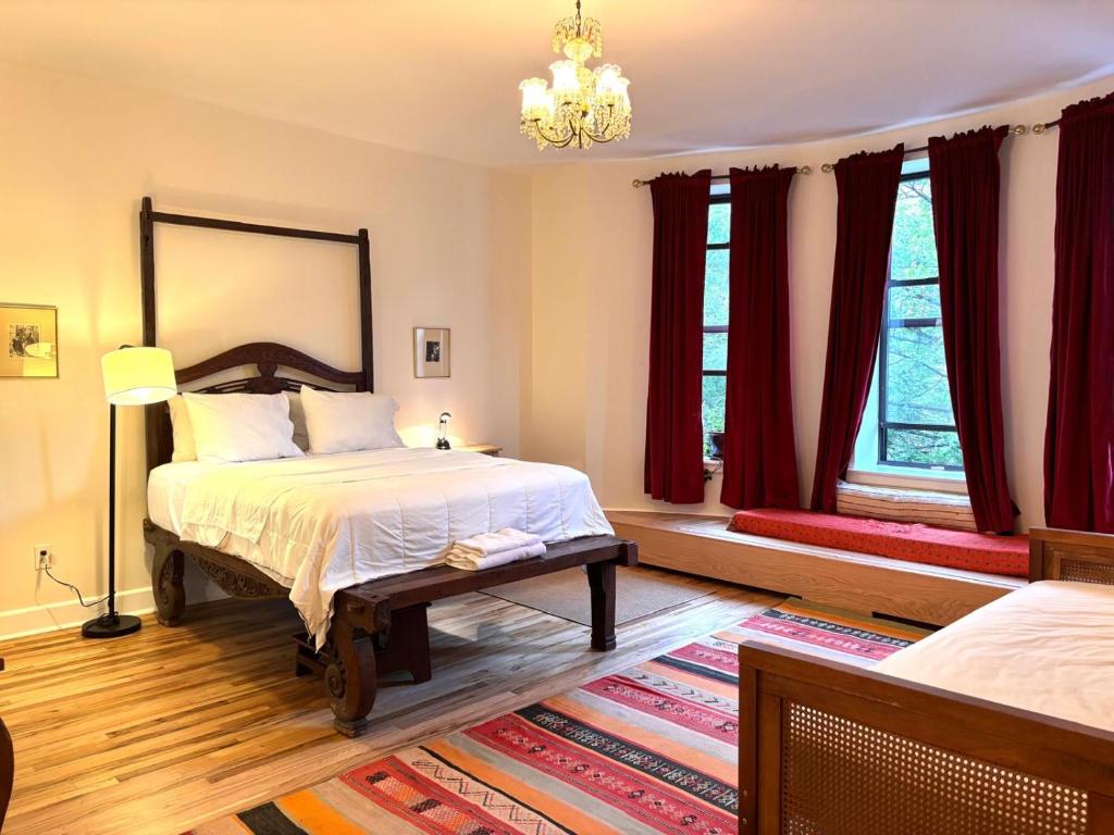 a bedroom with two beds and a chandelier at Luxurious bedroom in New York