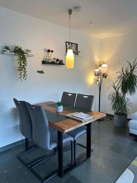 een eetkamer met een houten tafel en stoelen bij Penthouse ,,Kleine Auszeit" in Bad Harzburg