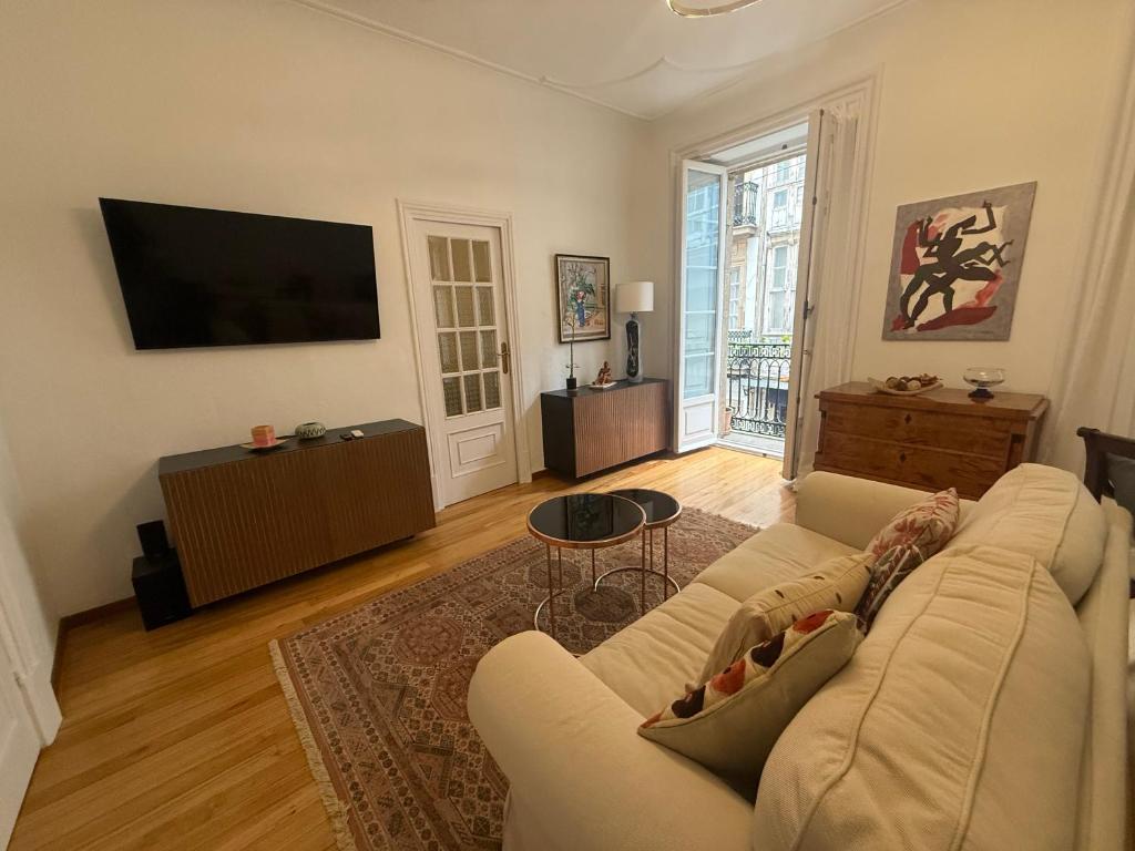 a living room with a couch and a flat screen tv at Estrecha de San Andres in A Coruña