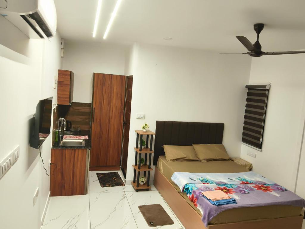 a bedroom with a bed and a tv in it at Flumen Resort in Ernakulam