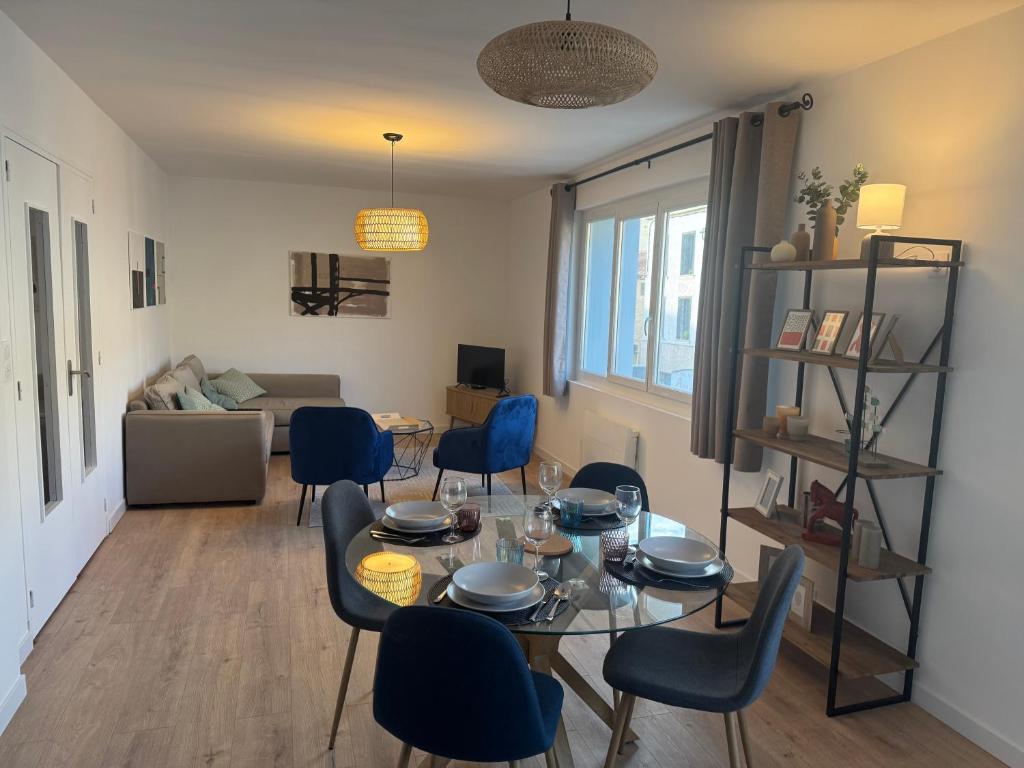 a living room with a table and chairs at Appartement centre ville Sigean in Sigean