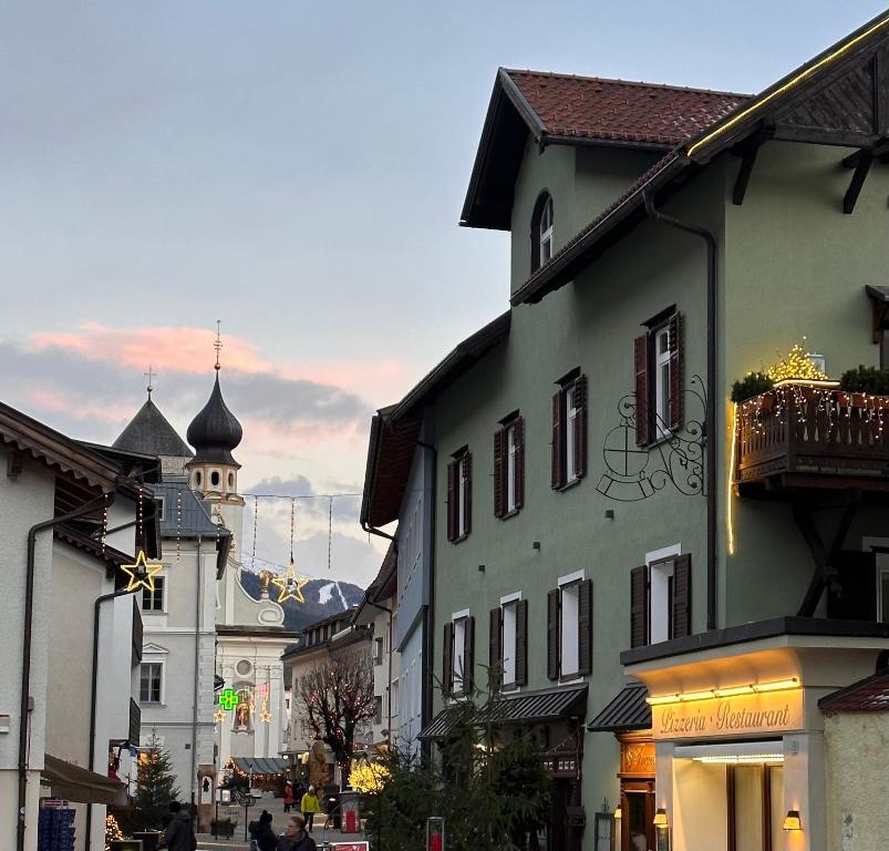 a city street with buildings and a clock tower at Zenana Boutique Hotel in San Candido