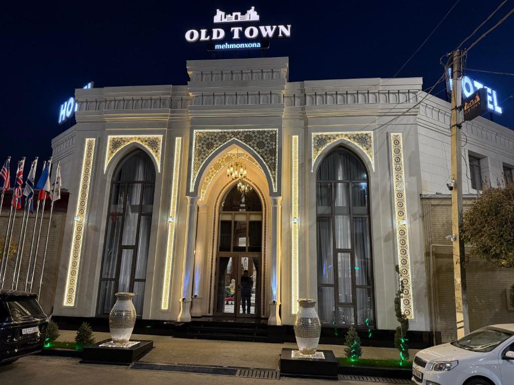 a large white building with lights in front of it at Oldtown1111 in Samarkand