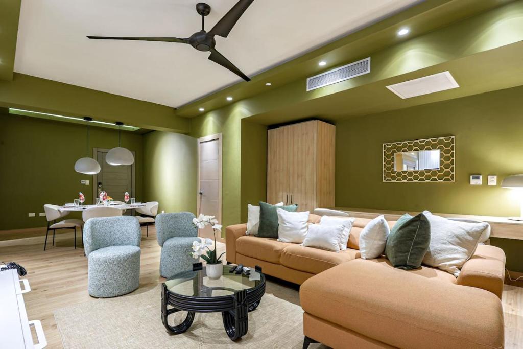 a living room with two couches and a table at Elegant and Cozy 1BD Condo in Ensanche Quisqueya