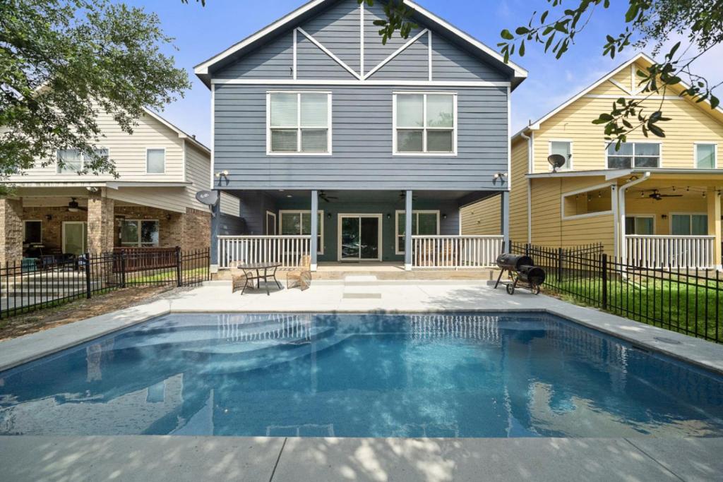 a house with a swimming pool in front of a house at Beautiful home with lake views and in-ground pool in West Livingston