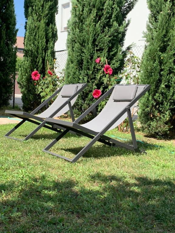 a bench sitting on the grass in a yard at Calipso in Abano Terme