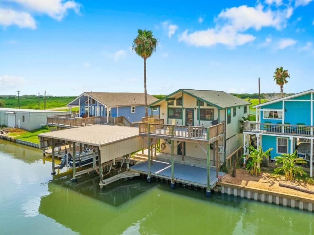a large house on a body of water at Waterfront beach house with the ultimate game room and two docks in Oyster Creek