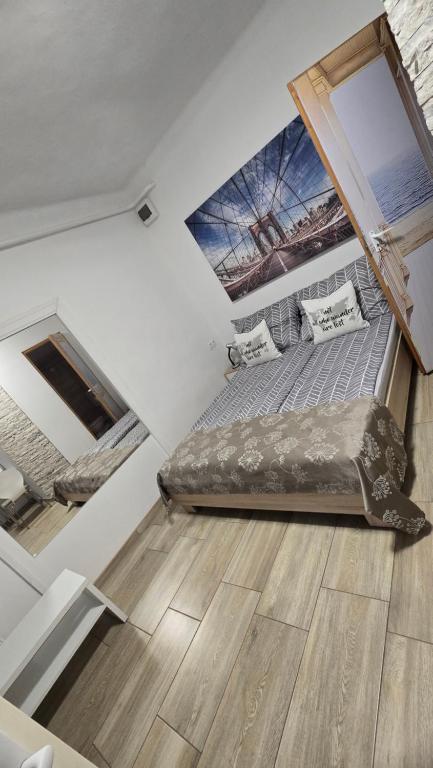 a bedroom with a bed in a room with a window at MP Center Magánszállás in Miskolc