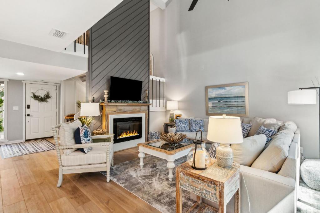 a living room with a couch and a fireplace at Beautifully remodeled 2 bedroom 2 bathrooms on the Marsh side of the resort in Franklintown