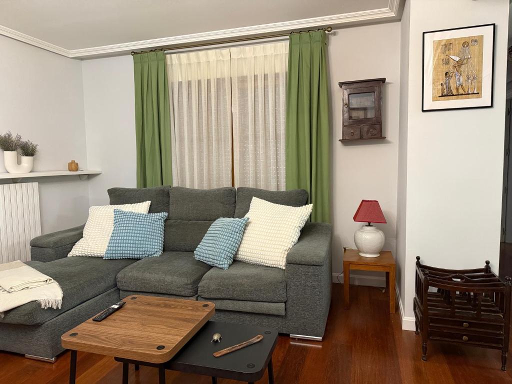 a living room with a couch and a table at 18 Torres Pasaje de los Giles in Zaragoza