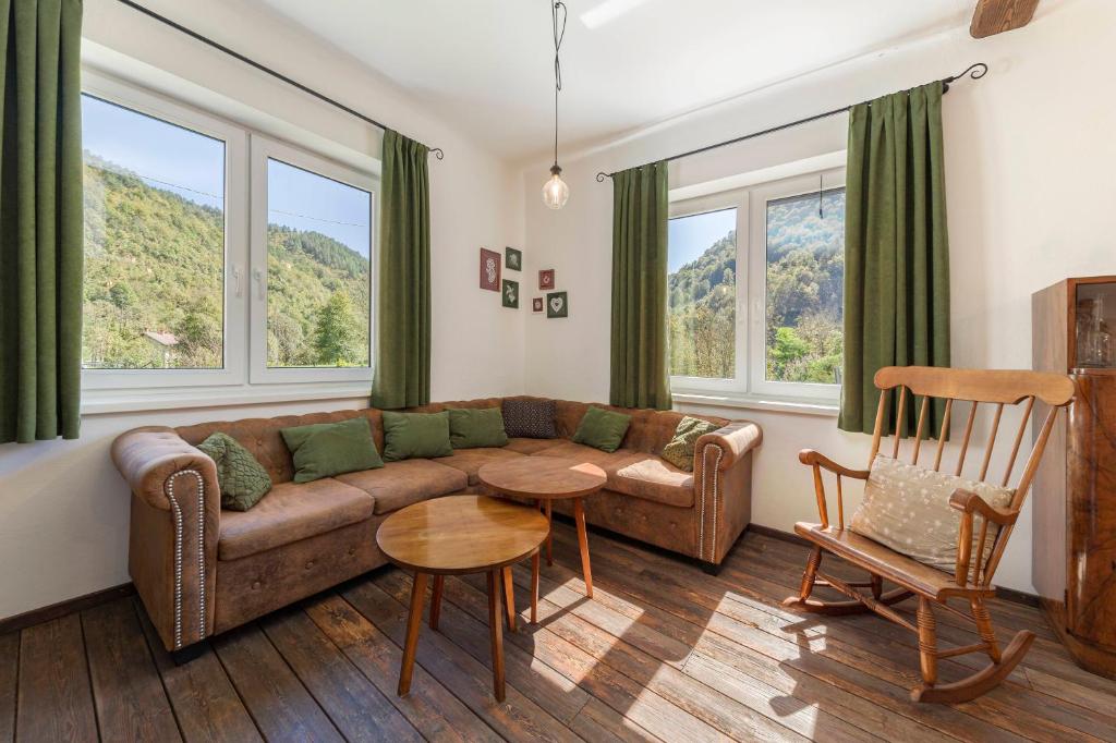 a living room with a couch and a table at doLodge homestead in the Kolpa River canyon in Stari Trg ob Kolpi