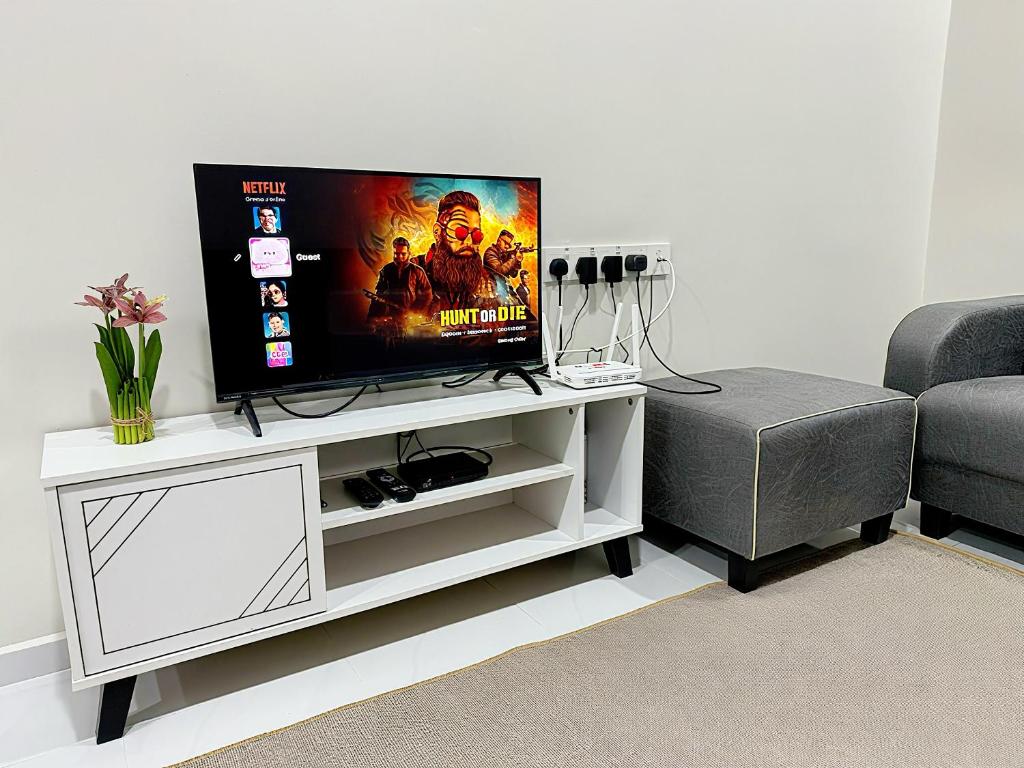 a flat screen tv sitting on a white entertainment center at Lunavista Homestay Jitra in Jitra