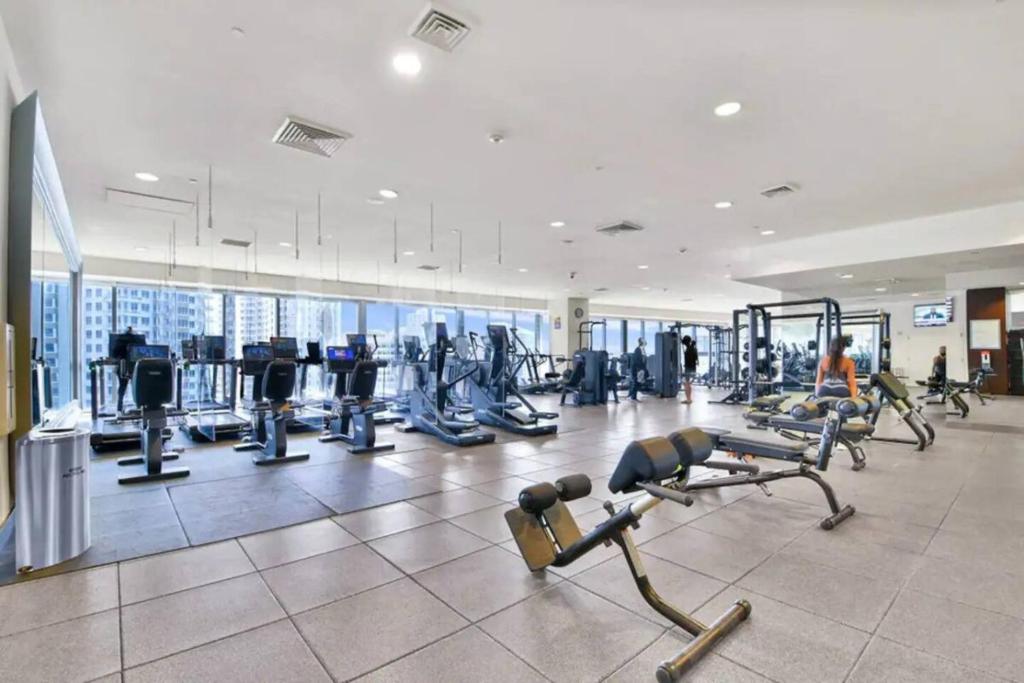 a gym with treadmills and machines in a building at Lavish Condo Breathtaking Views in Miami