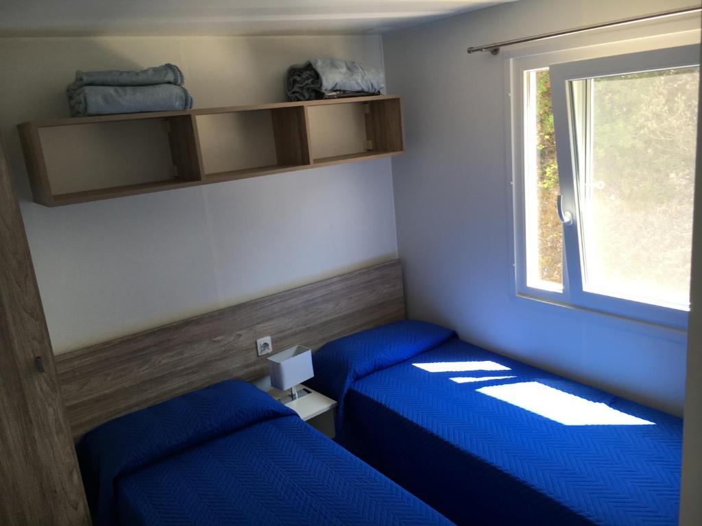 Postel nebo postele na pokoji v ubytování Camping Village La Sorgente