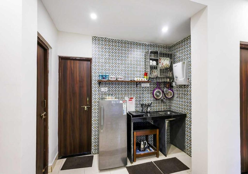 a kitchen with a stainless steel refrigerator and a counter at Susegad by Palette Homes in Candolim