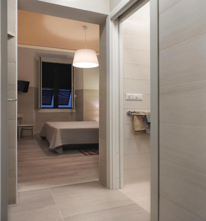 a room with a bed and a door leading to a bathroom at Albergo Annabella in Santa Margherita Ligure