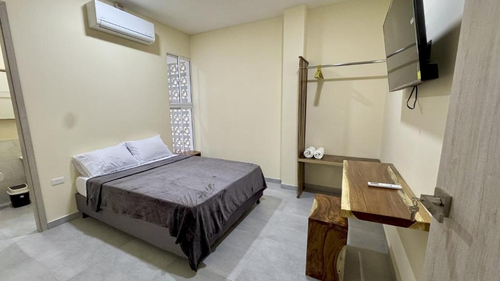 Ένα ή περισσότερα κρεβάτια σε δωμάτιο στο Nómada Private Rooms - Near Santa Marta Center