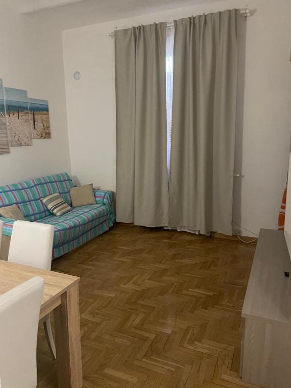 a living room with a couch and a table at Vista Vittorio Veneto in Follonica