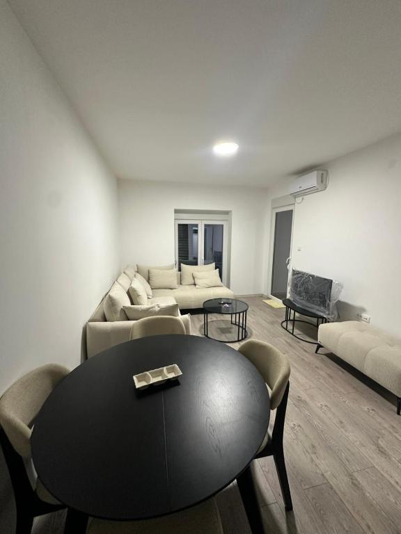 a living room with a table and a couch at Lacky-ca in Prokuplje