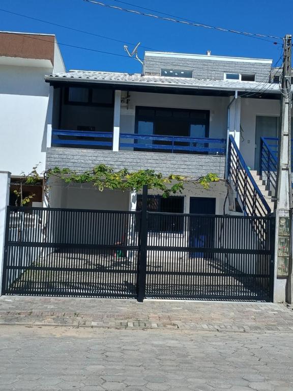 a house with a gate in front of it at Bela e Aconchegante in Bombinhas