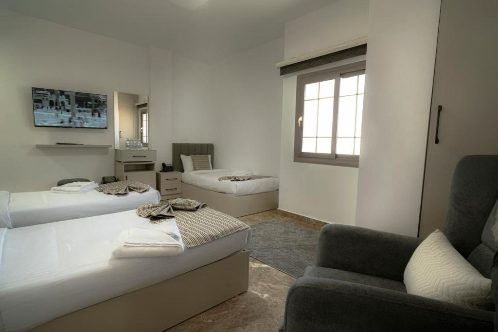 Giường trong phòng chung tại فندق قصر الياقوت