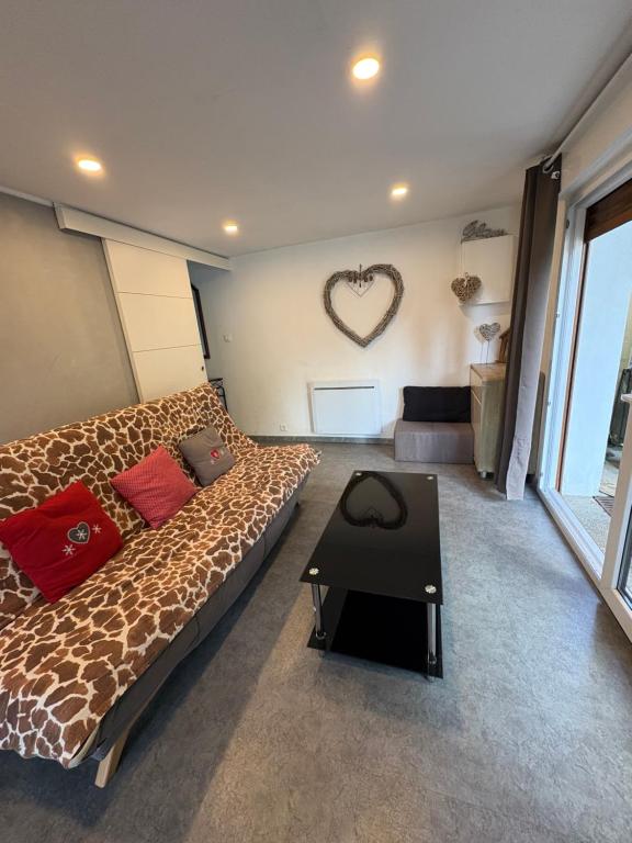 a bedroom with a large bed and a heart wall at GLAM in Saint-Jean-dʼArvey