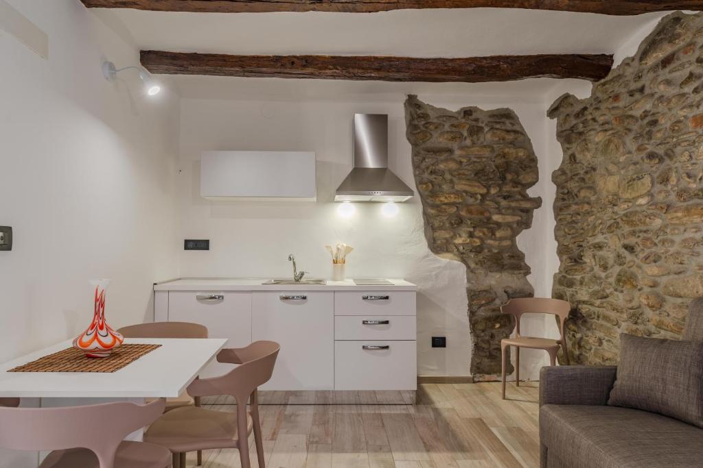a kitchen and dining room with a table and chairs at La Dimora delle Masche in Levone