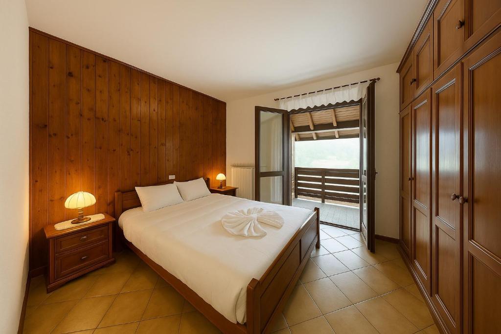 a bedroom with a large bed and a window at The Capriolo home in Tarvisio