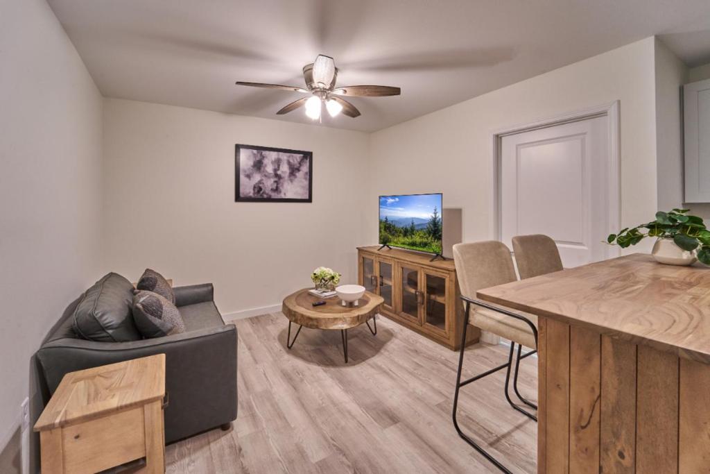 a living room with a couch a table and a tv at The Ruby 311 By Avada Properties in Pigeon Forge