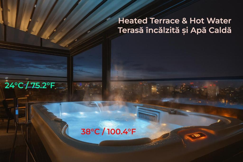 a hot tub in a room with a view of a city at Crown Penthouse - Luxurious, Spa & Vista , by Uni88 ApartHotel in Bucharest