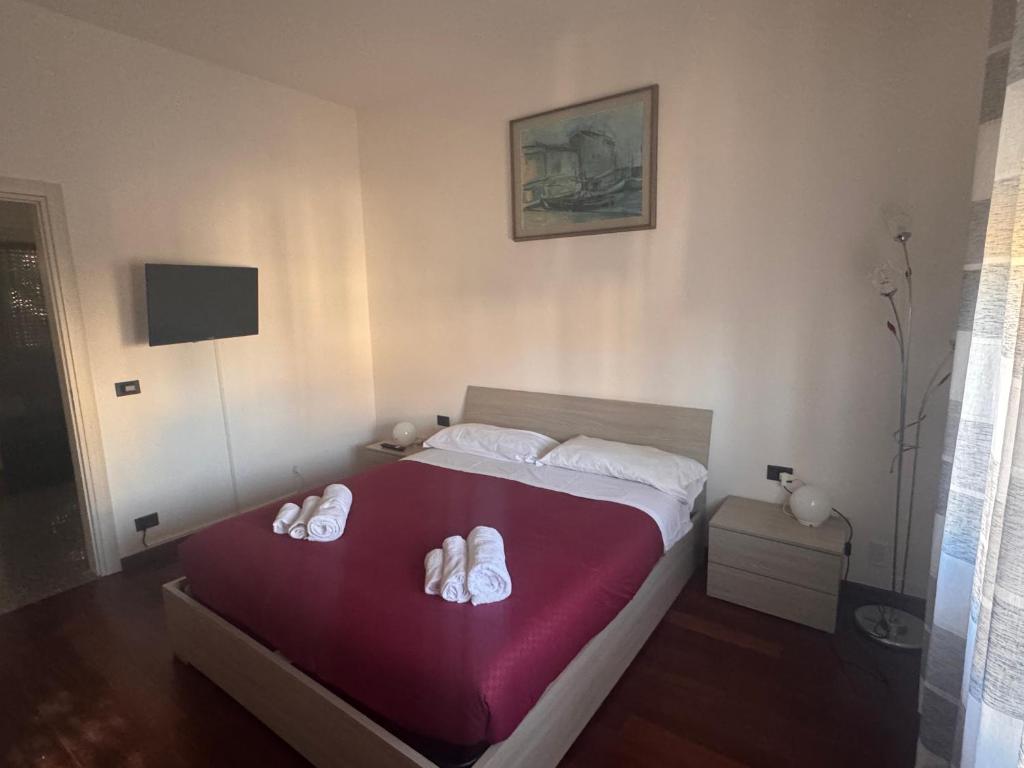 a bedroom with a bed with white shoes on it at Sweet charm in Venice in Tessera