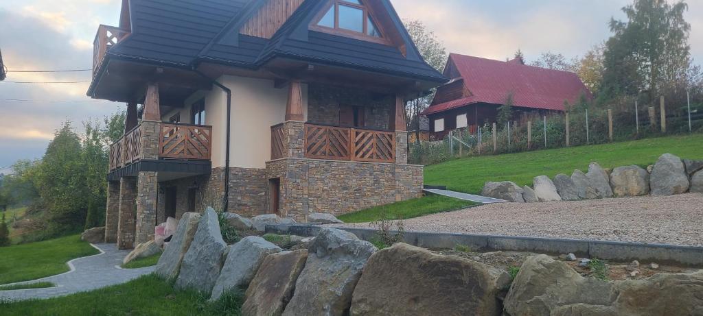 a house with a stone fence around it at DreamHill in Bustryk