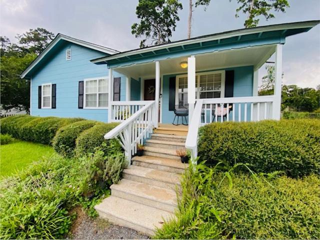 a blue house with a staircase in front of it at Midtown Cottage- Walk to Whole Foods in Tallahassee