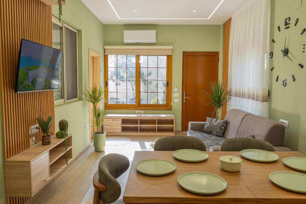 a living room with a table and a couch at Gus House Vlore in Vlorë