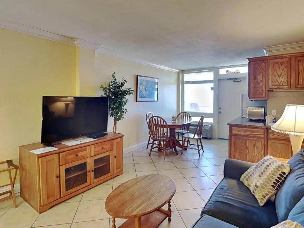 a living room with a couch and a table at Ocean Jewels Club 319 in Daytona Beach