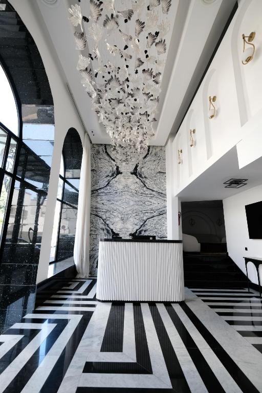 a lobby of a building with a chandelier at Chic Hotel in Rabat