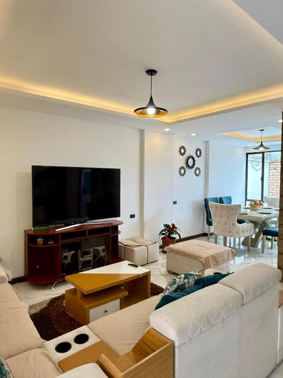 a living room with a couch and a flat screen tv at Pent House Exclusivo in Loja