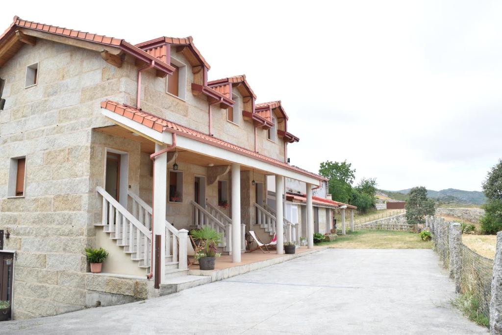 ein Steingebäude mit Treppen und Topfpflanzen darauf in der Unterkunft Casa Requias in Requiás