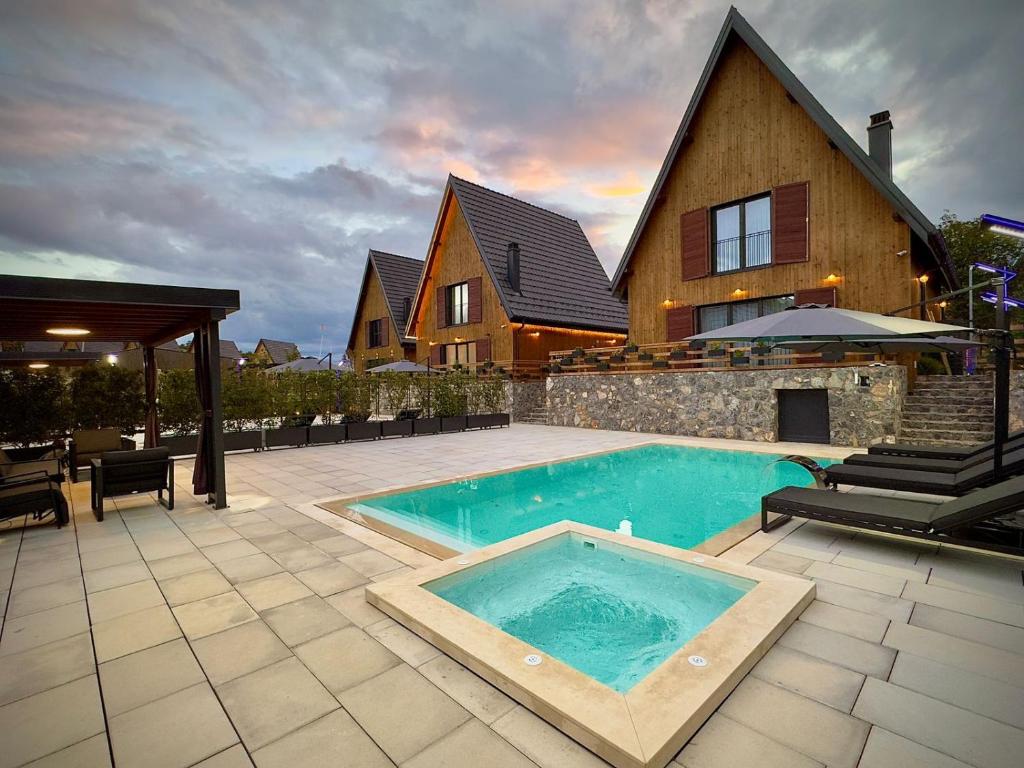 a swimming pool in front of a house at Casa Brava villas in Novoberdo