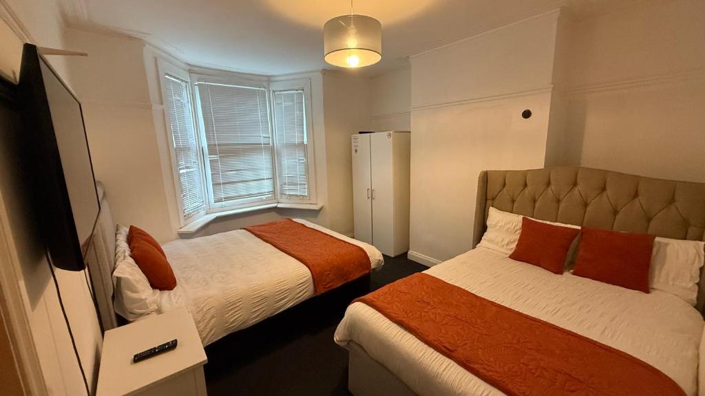a bedroom with two beds and a window at Saint Paul 01 in Bristol
