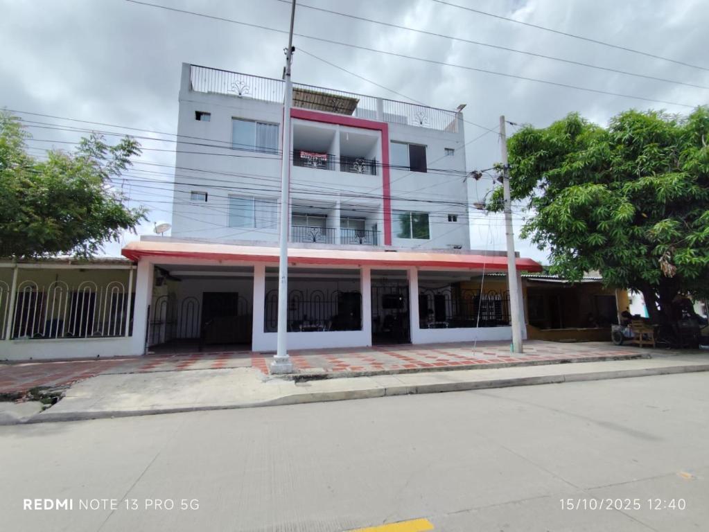 a building on the corner of a street at Hotel Madeleine Inn Sede Sur in Barranquilla