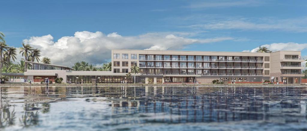 a large building with water in front of it at Hotel Eastport in The Villages