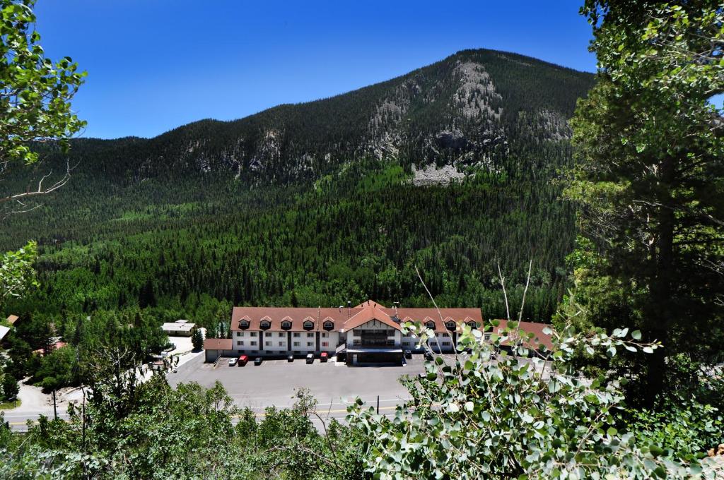 a building with a parking lot in front of a mountain at Monarch Mountain Lodge in Monarch