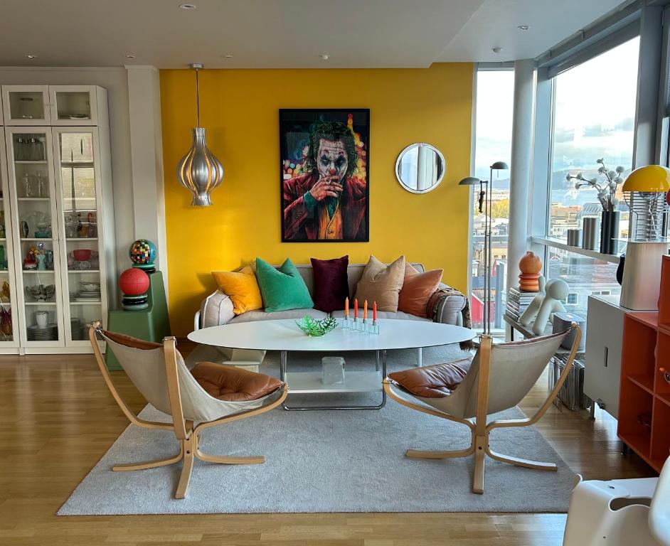 a living room with a couch and a table at ArticVieW Tromsø city centre in Tromsø