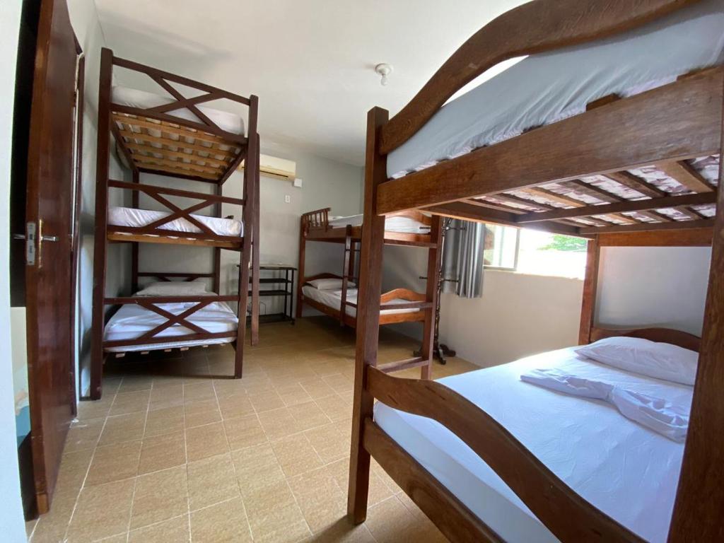 a room with three bunk beds in a house at Maréia Hostel in Salvador
