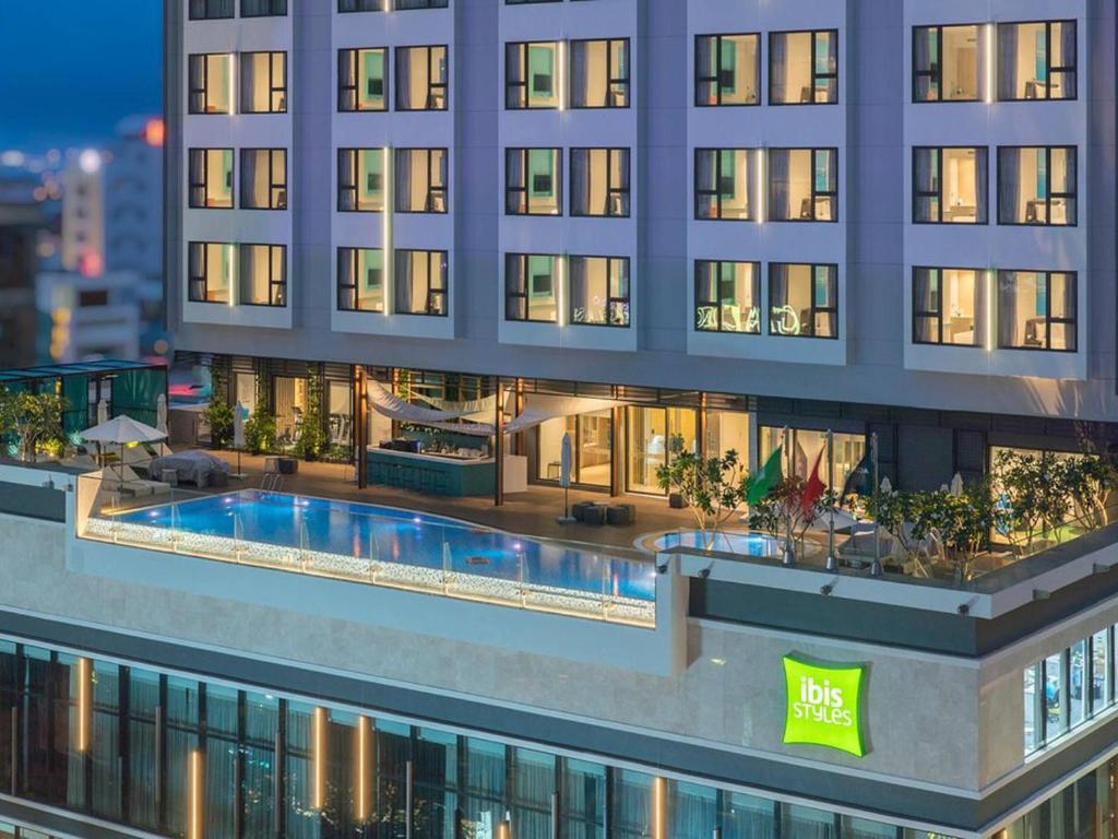 an aerial view of a building with a swimming pool at ibis Styles Nha Trang in Nha Trang