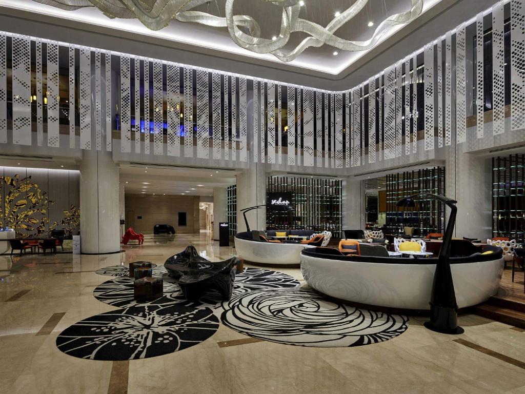 a lobby with two bath tubs in a building at Pullman Kuala Lumpur City Centre Hotel & Residences in Kuala Lumpur