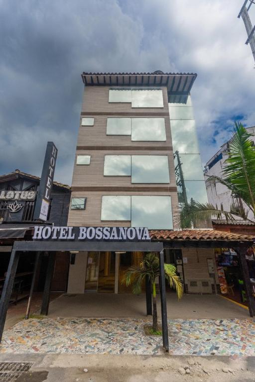 a hotel with a sign in front of a building at Hotel Bossanova in Rionegro