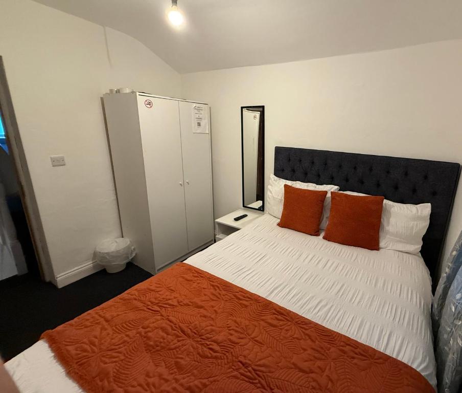 a bedroom with a bed with orange and white pillows at Saint Paul 03 in Bristol